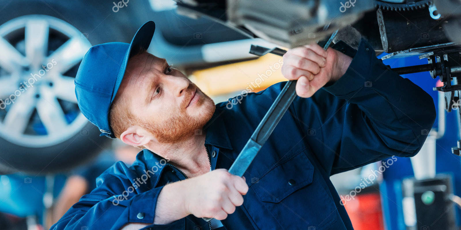 depositphotos_163506704-stock-photo-automechanic-working-on-car